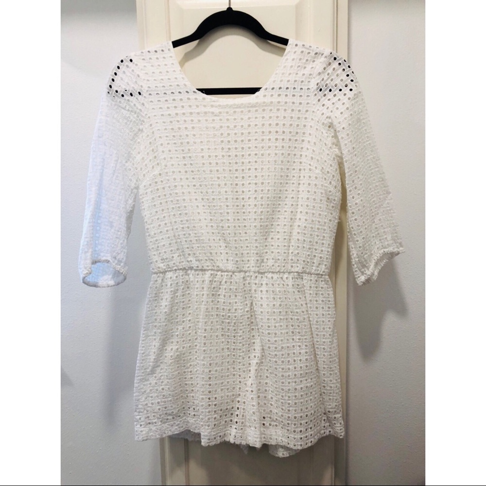 Adorable eyelet romper with bow detail on the back